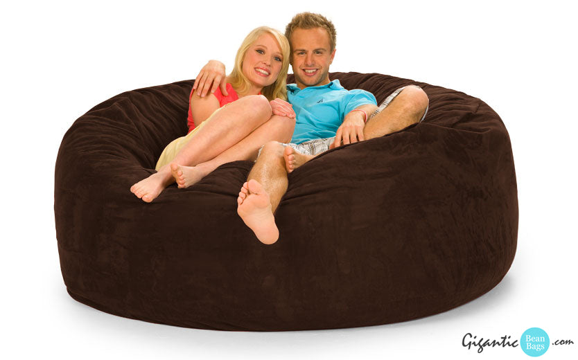 A couple sitting on a Chocolate Brown Bean Bag Chair.