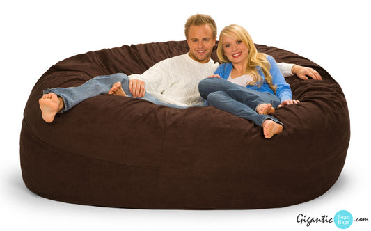 A happy couple resting on a 7 foot by 7 foot Chocolate Brown bean bag chair.