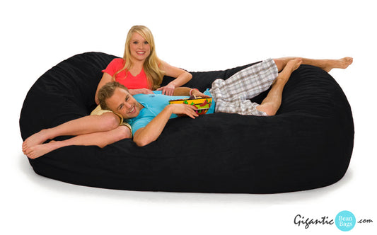 Happy couple on a black bean bag lounger, 7.5 foot model.