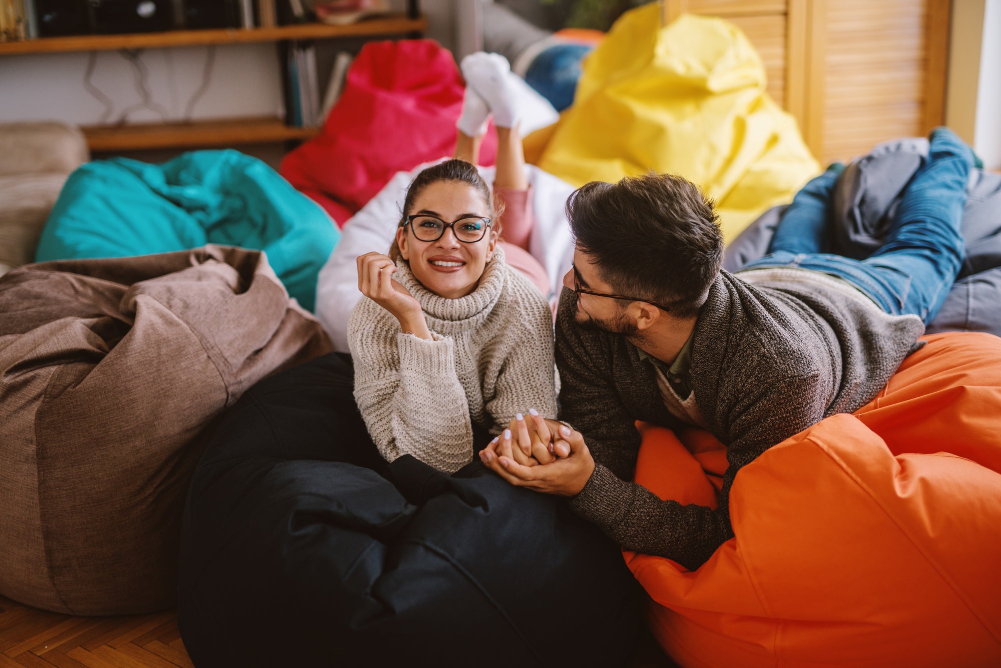 Gigantic Bean Bags main image showing a man and woman relaxing on several large bean bags.