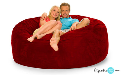 6 ft Red Bean Bag Chair with 2 people on it.