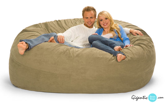 Beige bean bag chair with two people on it.