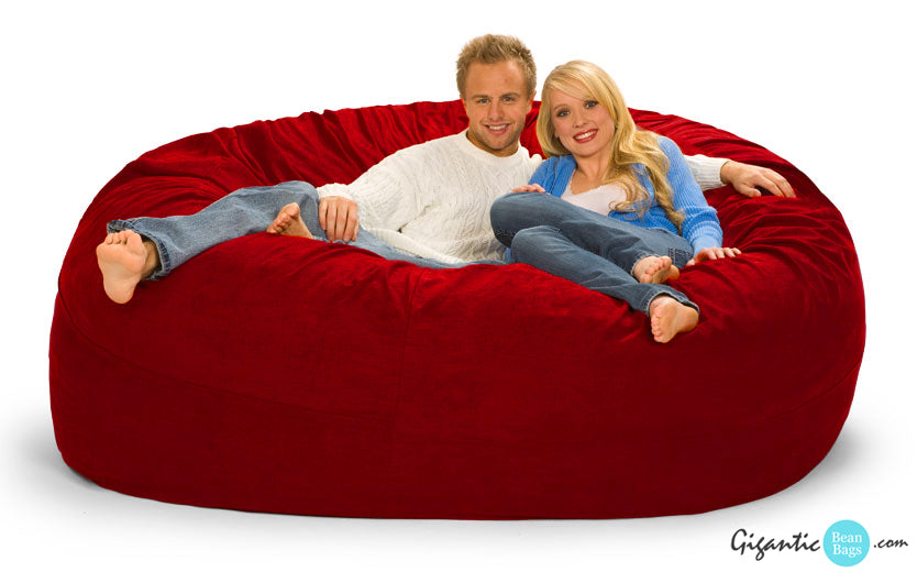 7 ft Bean Bag Chair in a bold, vibrant red. Small company logo at the bottom right.