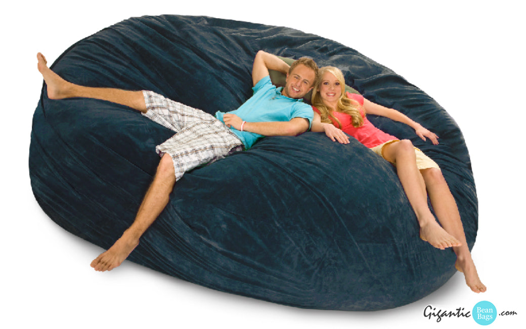 Navy blue bean bag bed, 8 ft x 8 ft, with a happy couple relaxing on it.