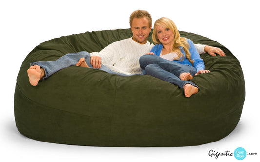 Olive green bean bag chair, 7 ft, round shape, 2 people sitting on it.