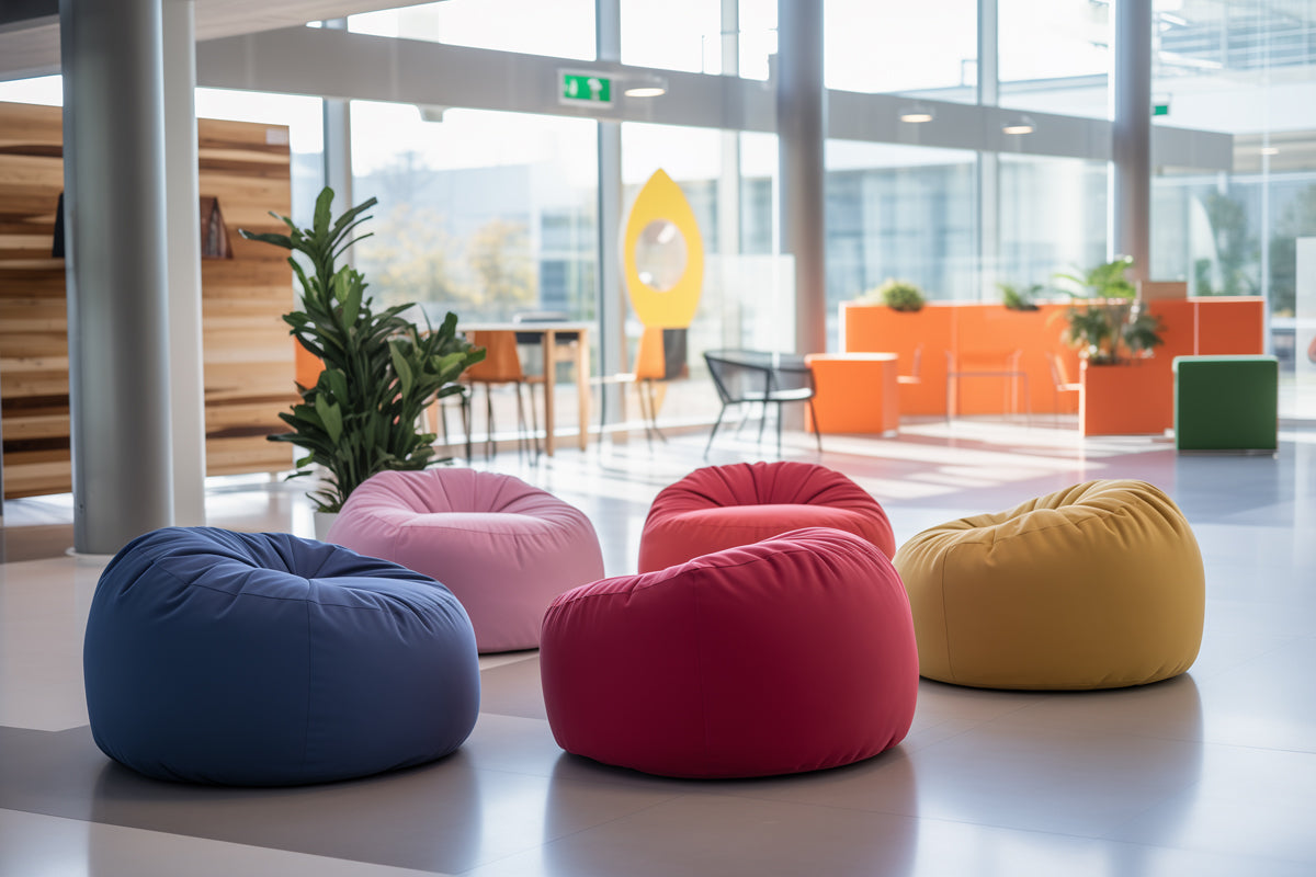 5 round bean bag chairs in an office setting. It's a wide and spacious workplace environment with large windows.