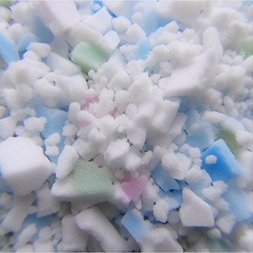 An overhead shot of our 100% recycled polyurethane foam that goes inside our bean bags. The foam is shredded up into bits of white, blue, and green.