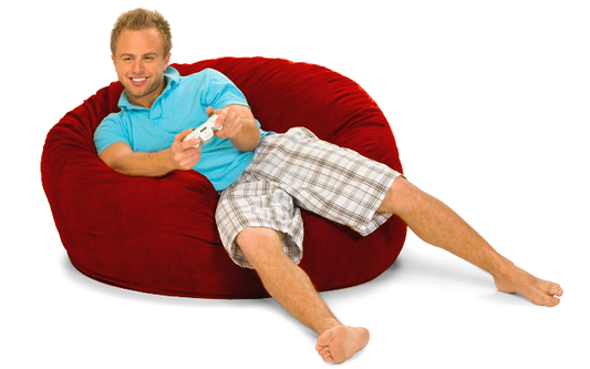A man playing video games on a red 4 ft. Round bean bag sold by Gigantic Bean Bags.