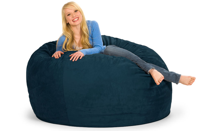 Woman smiling and relaxing on a Navy Blue 5 ft. Bean Bag Chair.