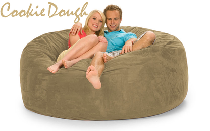 Cookie Dough Tan 6 ft Bean Bag Chair with a man and woman on it.
