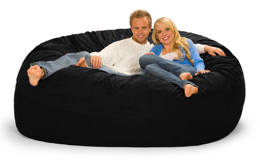 A man and a woman lounging on a 7 ft. Bean Bag in Designer Black with a white background.